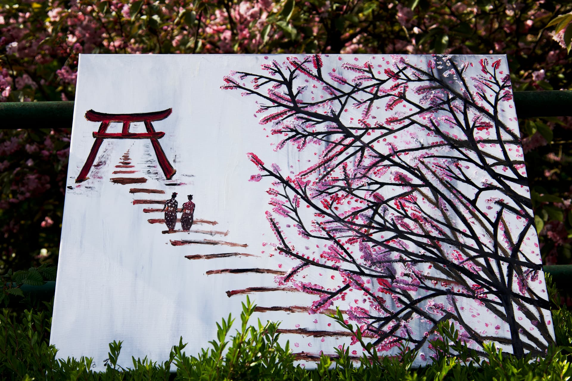 An oil painting of blossoming pink sakura branches.